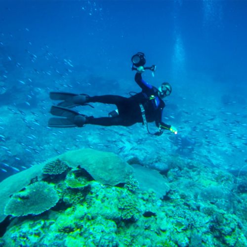 Scuba diver underwater with camera