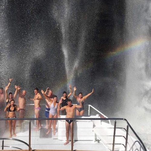 Great Escape guests being showered by waterfall spray on the top deck